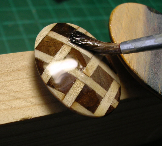 close-up of hands working on marquetry jewellery